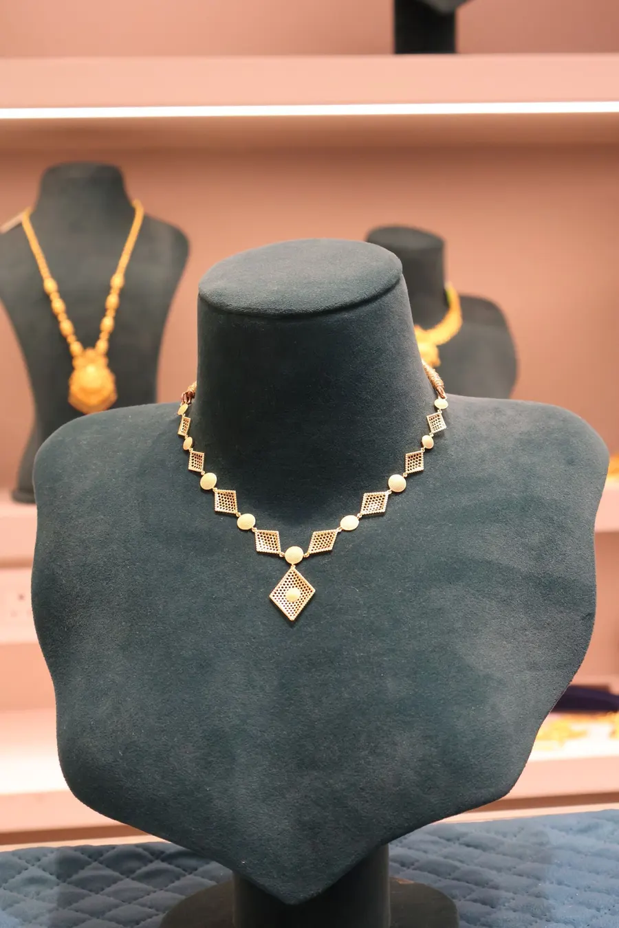 A necklace on a velvet bust inside the store